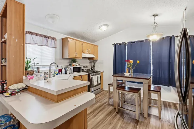 a view of kitchen with sink microwave and cabinets