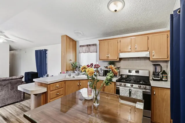 a kitchen with a sink appliances and cabinets