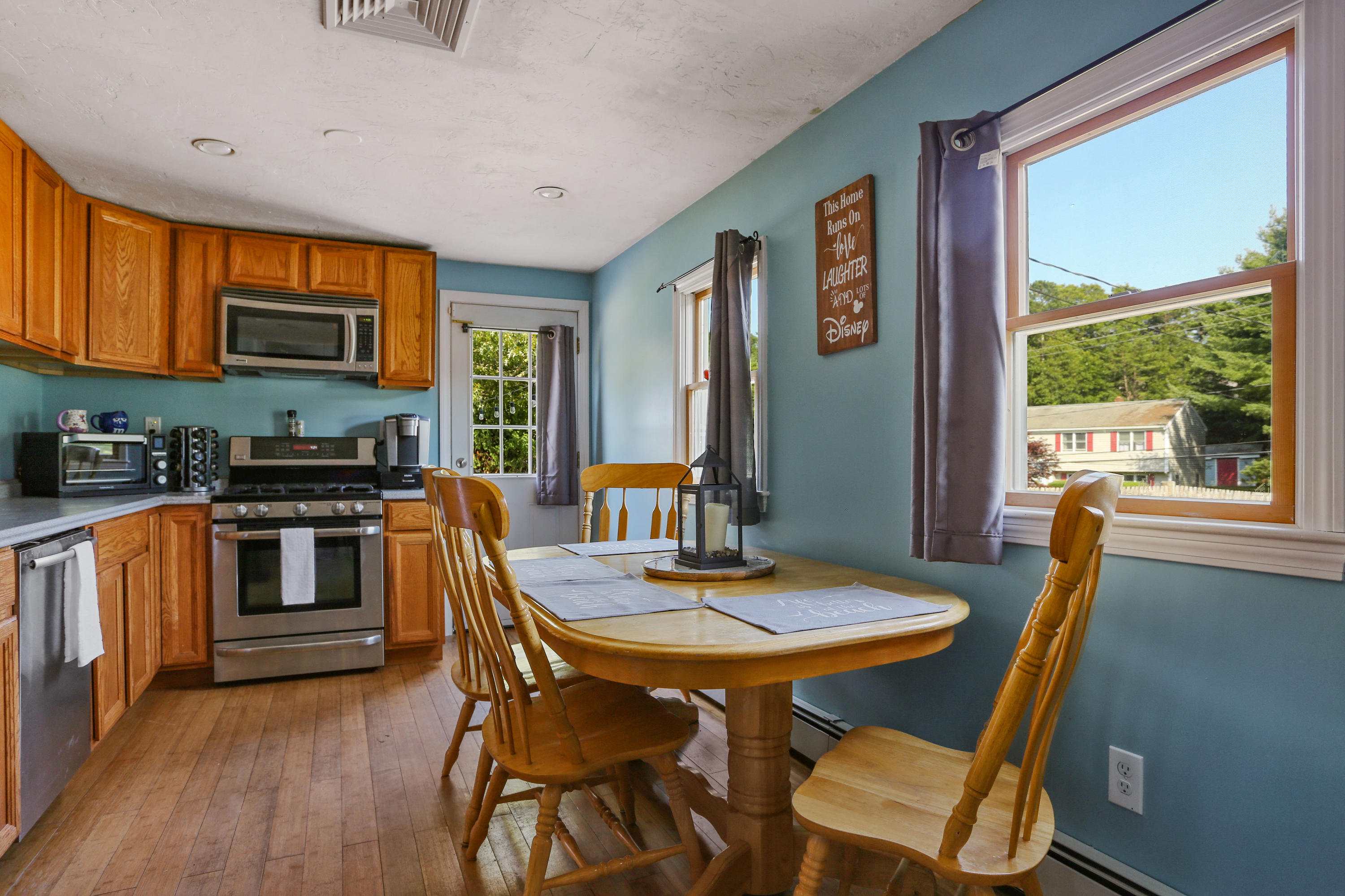 97 Valley Bars Road Pocasset, MA 02559 - Photo 3 of 15 a view of a dining room with furniture window and wooden floor