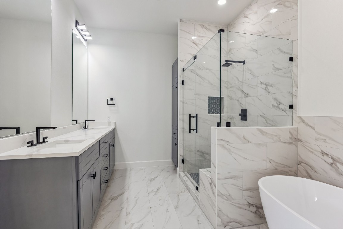 9426 Campbell Road, Unit A Houston, TX 77080 - Photo 11 of 17 Exquisite primary bathroom showcasing gleaming quartz countertops with dual sinks, combining timeless elegance with practical luxury.