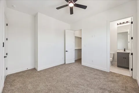 a view of a hallway with wooden floor and closet area