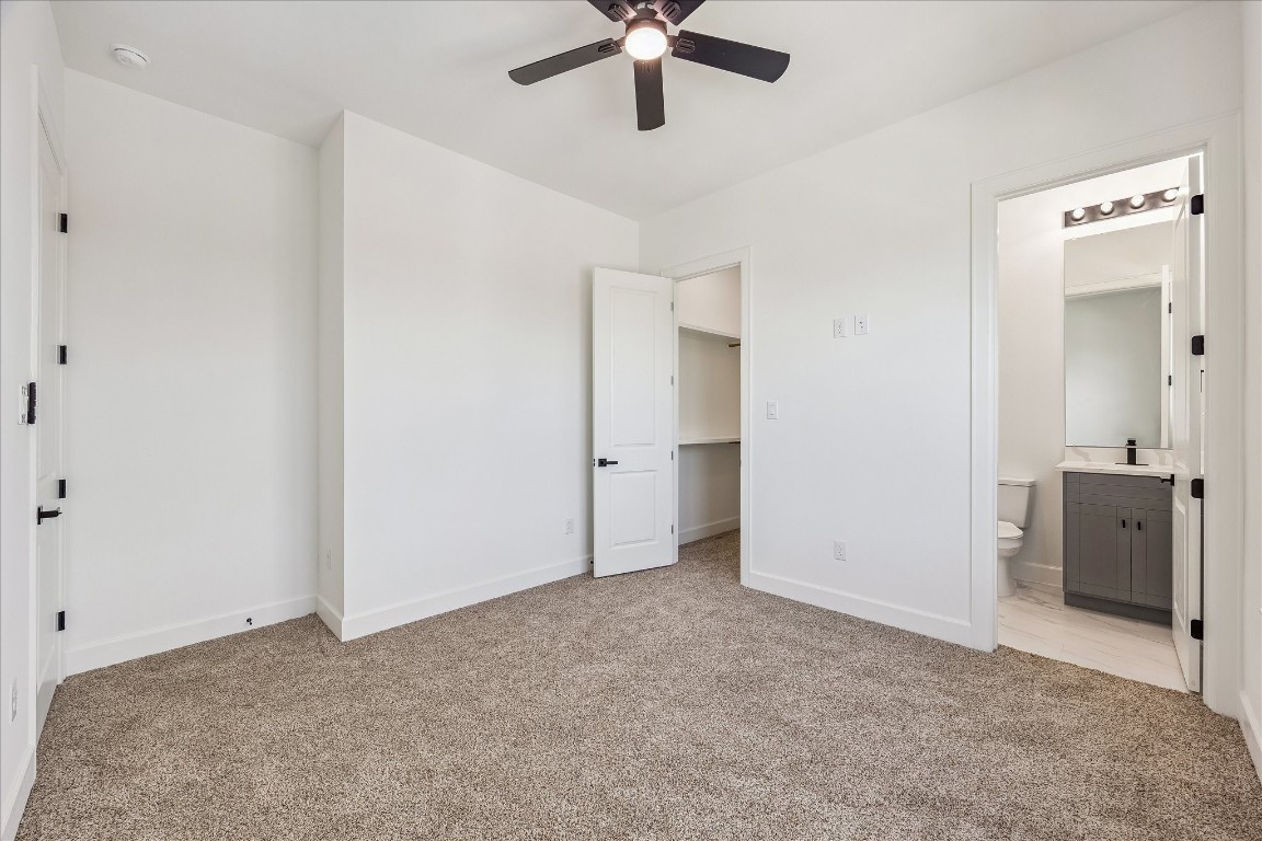9426 Campbell Road, Unit A Houston, TX 77080 - Photo 14 of 17 Well-appointed third-floor secondary bedroom, positioned just across from the primary suite, featuring a private ensuite bathroom and a generously sized closet for ample storage and ease of use.