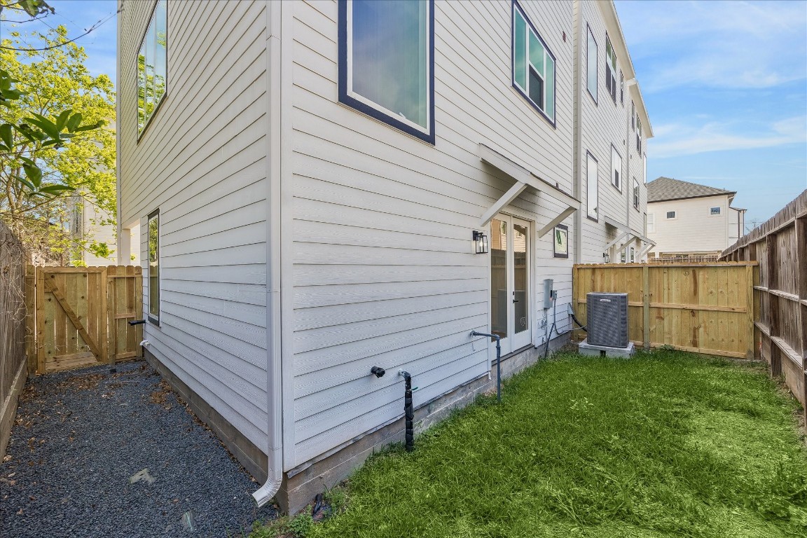 9426 Campbell Road, Unit A Houston, TX 77080 - Photo 15 of 17 Securely enclosed backyard with gated access, complemented by a charming pebbled side yard for added privacy and low-maintenance appeal.