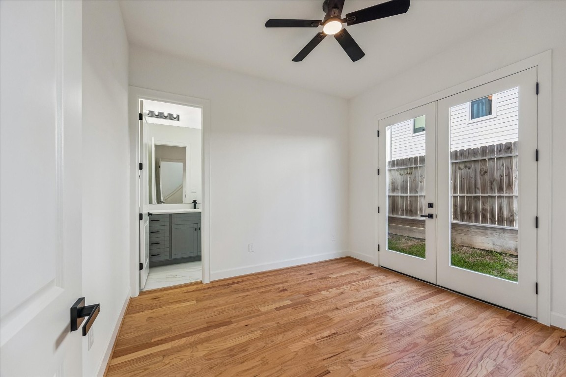 9426 Campbell Road, Unit A Houston, TX 77080 - Photo 3 of 17 Convenient first-floor bedroom featuring private backyard access and a well-appointed en-suite bath—ideal for guests or multigenerational living