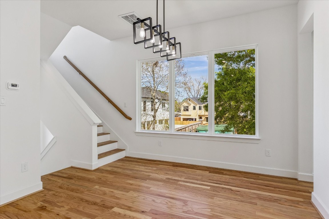 9426 Campbell Road, Unit A Houston, TX 77080 - Photo 6 of 17 Upon ascending to the second floor, you are welcomed by an open-concept layout that flows seamlessly into the dining area, elegantly illuminated by a modern chandelier.