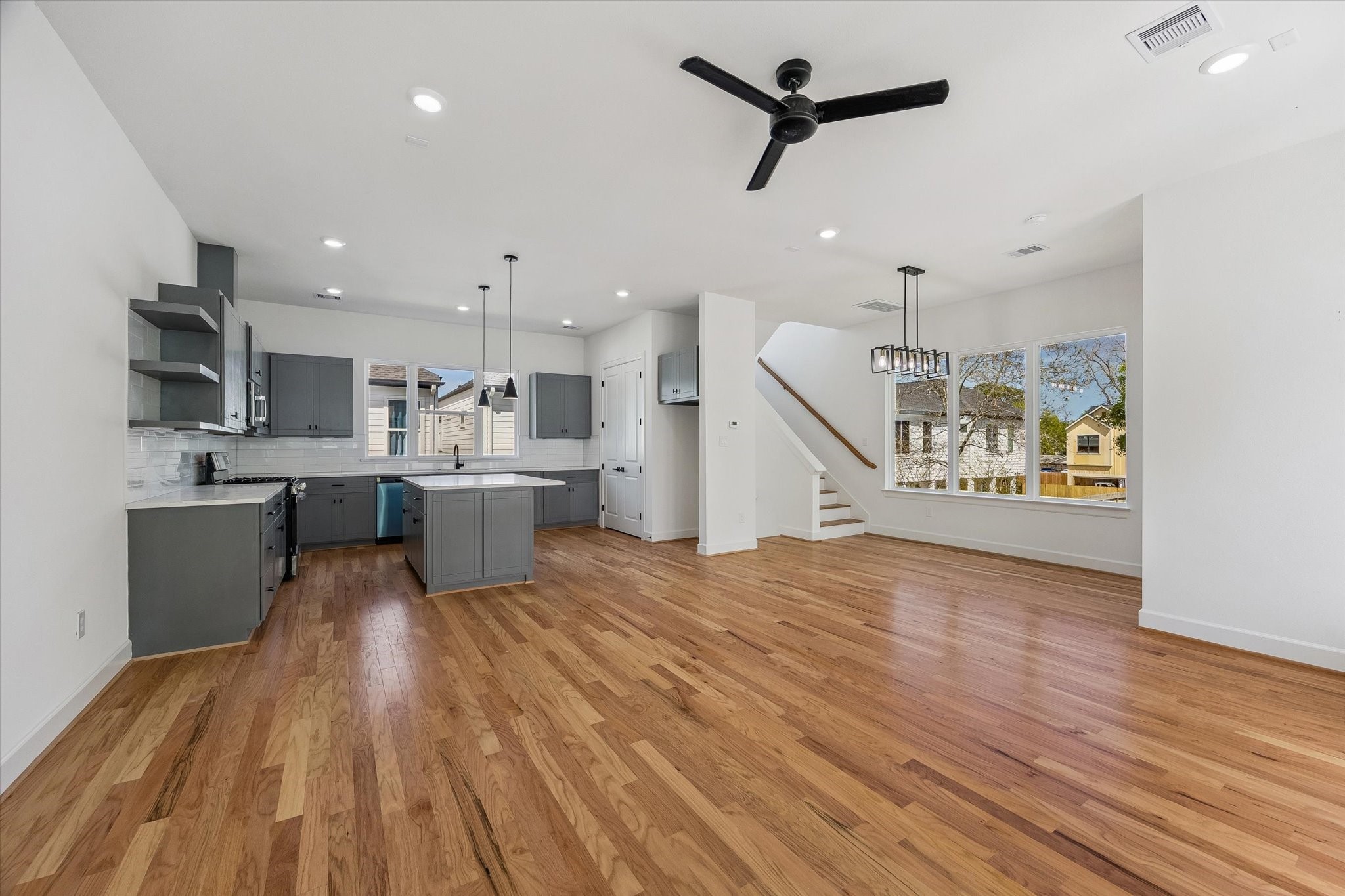 9426 Campbell Road, Unit A Houston, TX 77080 - Photo 7 of 17 a large kitchen with cabinets wooden floor and stainless steel appliances