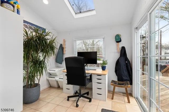 a view of a workspace with furniture and a potted plant