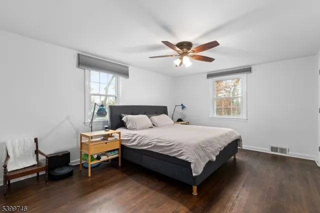 a bedroom with a bed a chandelier and a window