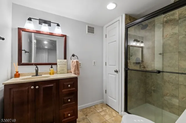 a bathroom with a sink a mirror and shower
