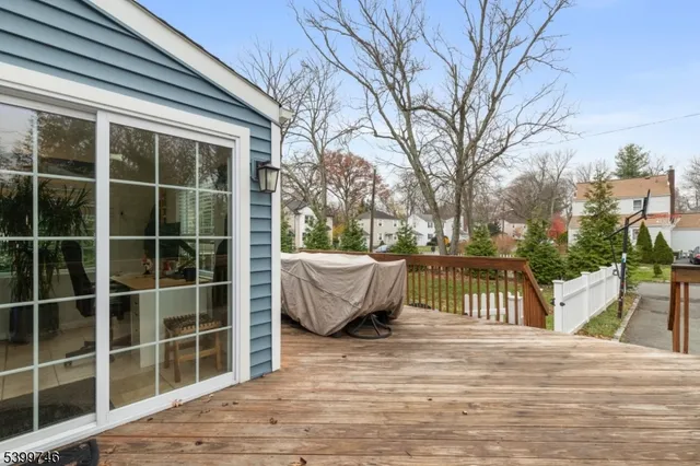 a view of a roof deck with couches and wooden floor