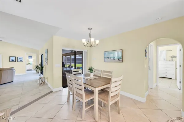 a view of a dining room with furniture and chandelier