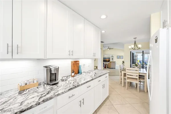 a kitchen with sink a table and chairs