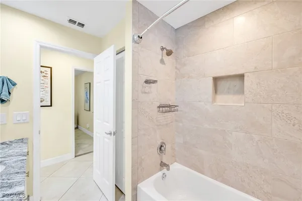 a bathroom with a bathtub and shower