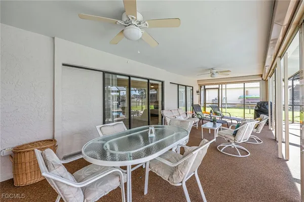 a dining room with furniture a chandelier and window