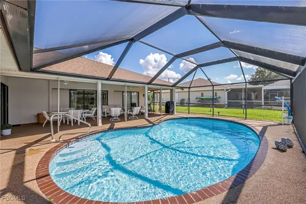 a house view with swimming pool and glass windows