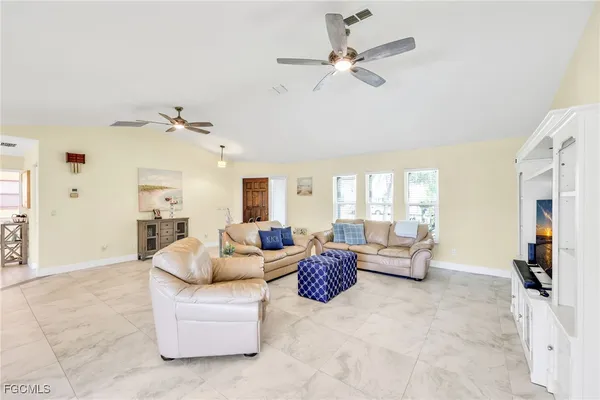 a living room with fireplace furniture and a large window