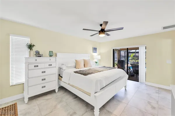 a bedroom with a large bed and a chandelier