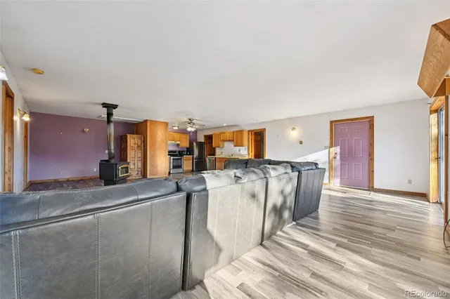 a kitchen with stainless steel appliances kitchen island granite countertop a refrigerator and a stove top oven