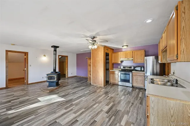 a kitchen with a sink stove and refrigerator