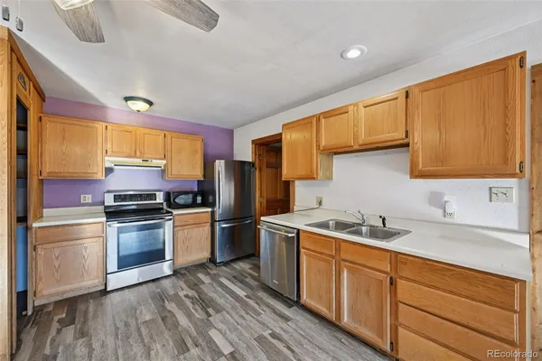 a kitchen with a stove and a refrigerator