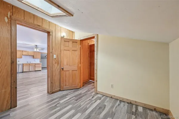 a view of an empty room with wooden floor
