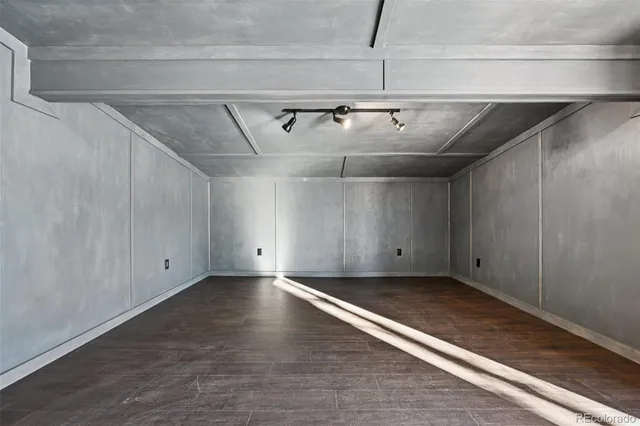 a view of empty room with wooden floor and closet