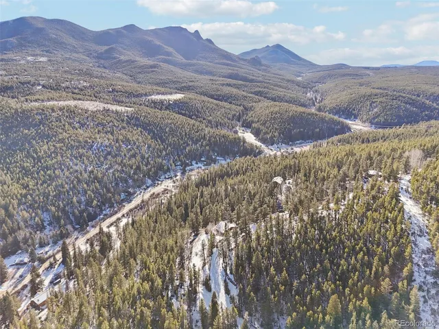a view of a house with a yard and deck
