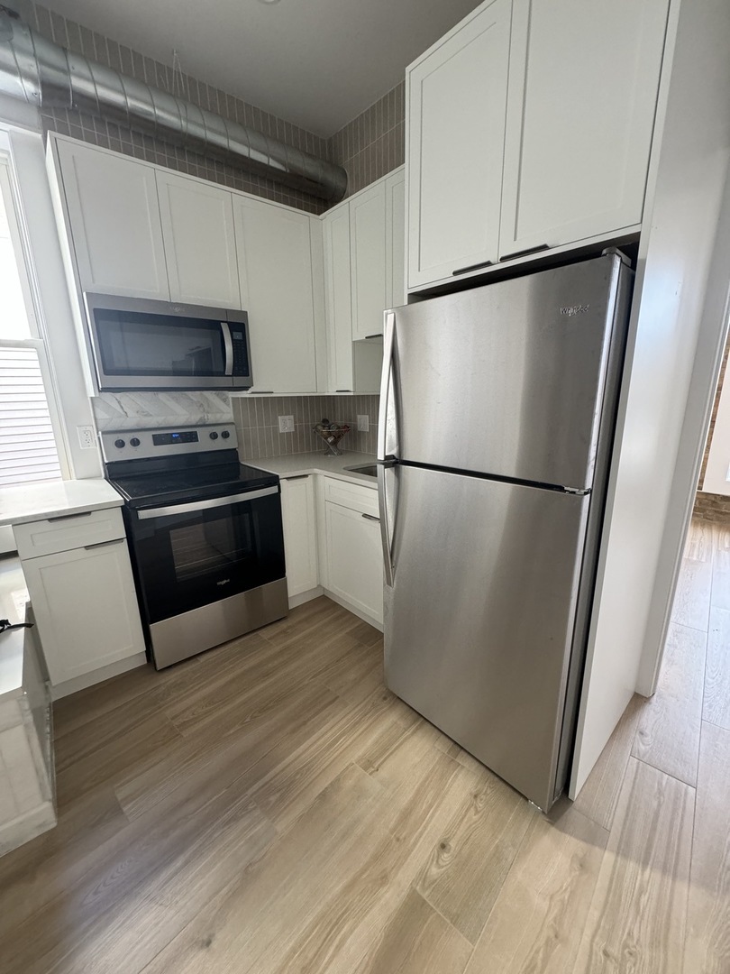 601 Green Bay Road, Unit 204 Wilmette, IL 60091 - Photo 8 of 19 a white refrigerator freezer and a stove sitting inside of a kitchen