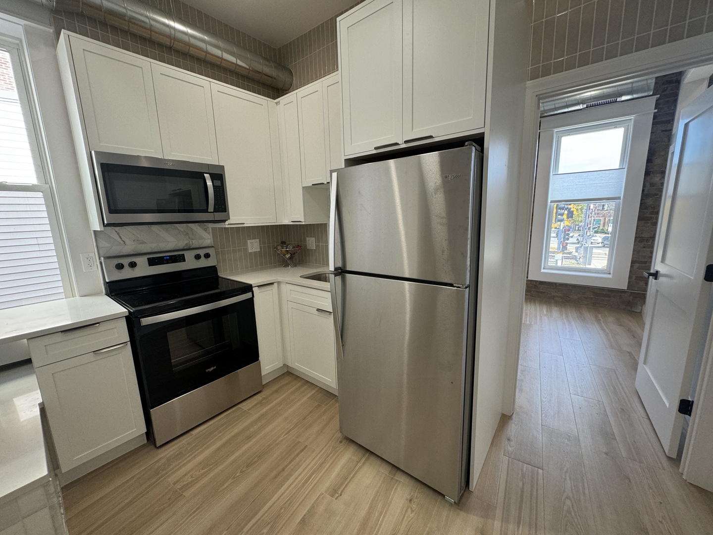 601 Green Bay Road, Unit 204 Wilmette, IL 60091 - Photo 9 of 19 a kitchen with a refrigerator stove and wooden cabinets