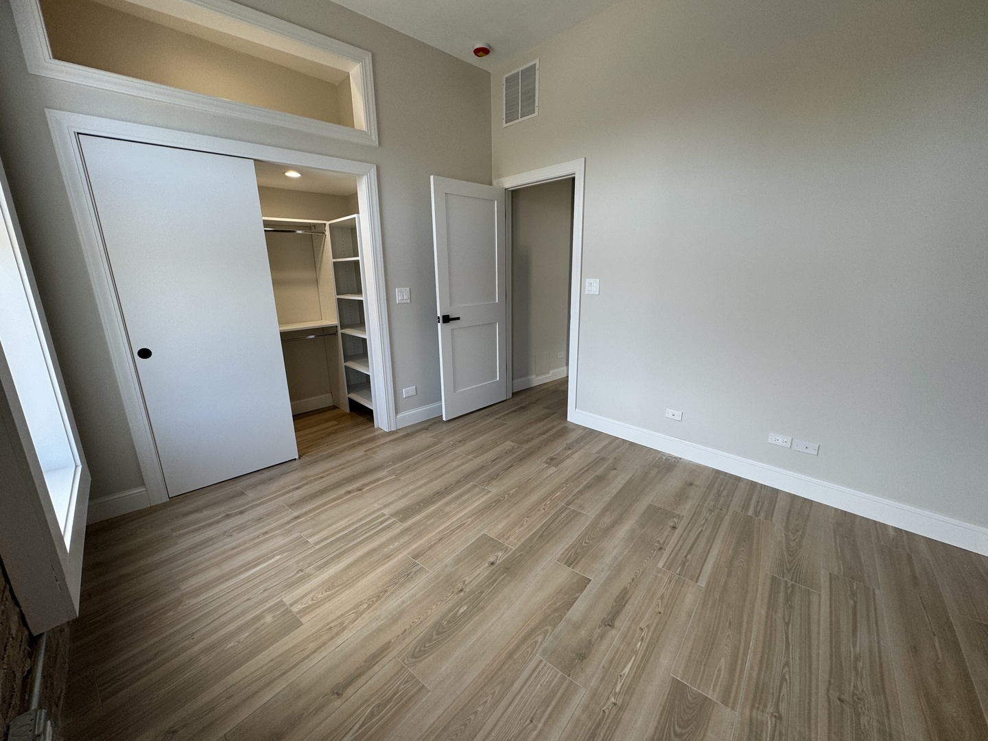 601 Green Bay Road, Unit 204 Wilmette, IL 60091 - Photo 10 of 19 a view of an empty room with wooden floor and a window