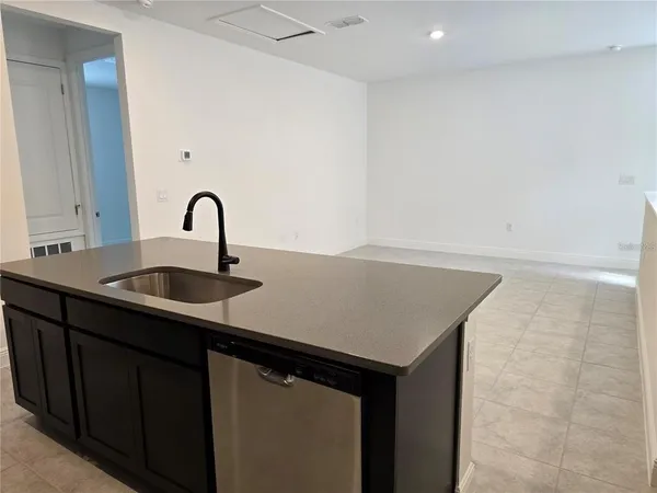 a close view of a sink a faucet and appliance in the kitchen