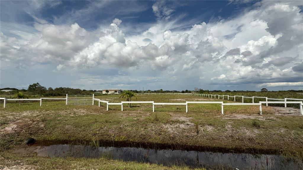 20375 Northwest 248th Street Okeechobee, FL 34972 - Photo 2 of 4 a view of a lake with houses in the back