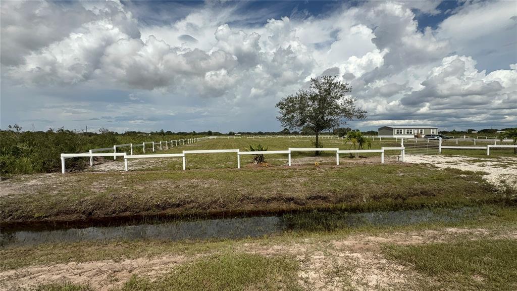 20375 Northwest 248th Street Okeechobee, FL 34972 - Photo 3 of 4 a view of a lake with houses in the back
