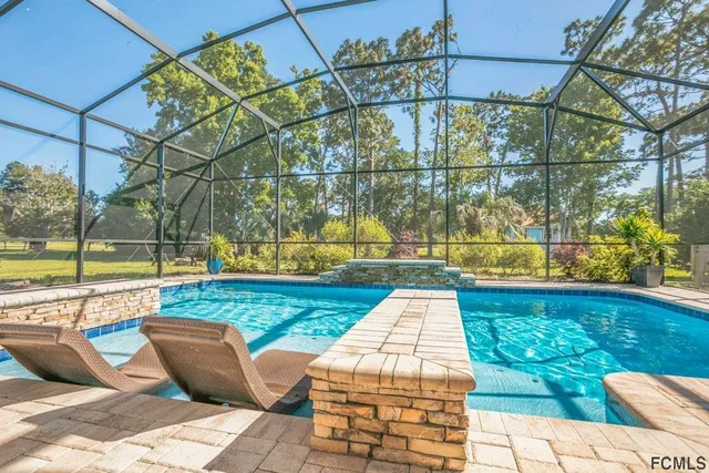 a view of swimming pool with lounge chair
