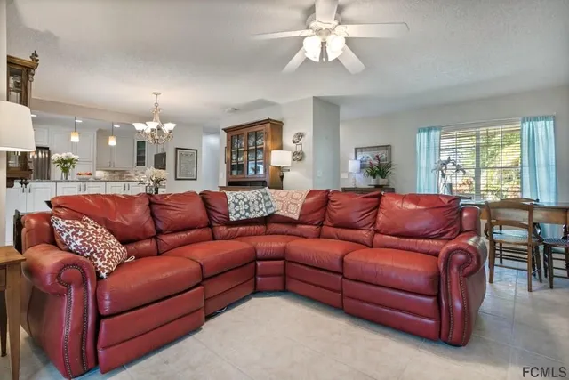 a view of a dining room with furniture and a chandelier