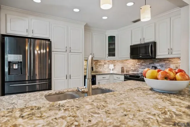 a view of a dining room with furniture and a chandelier