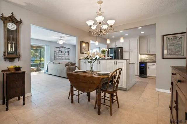 a bedroom with a bed chandelier and a window