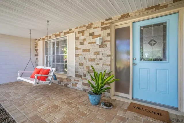 a backyard of a house with outdoor seating