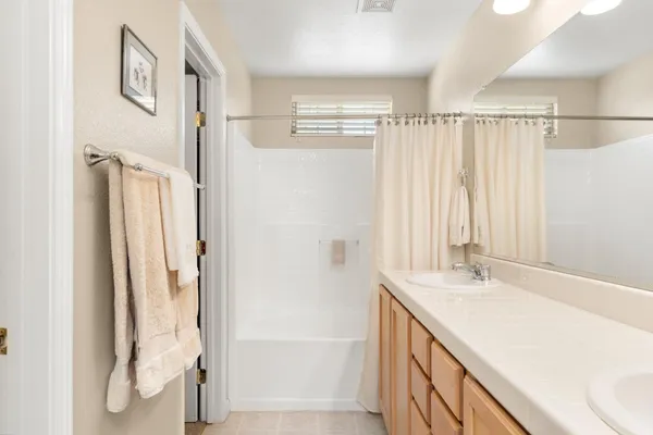 a view of a walk in closet with clothes