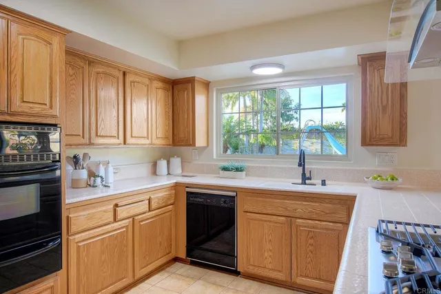 a kitchen with a sink stove top oven and cabinets