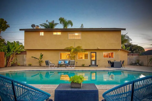 swimming pool view with a seating space