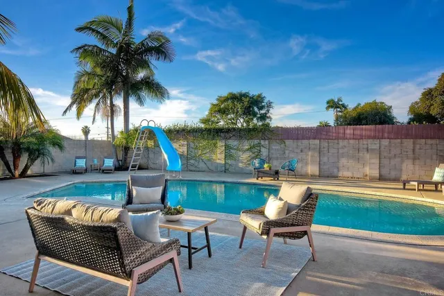 an outdoor sitting area with furniture and wooden floor