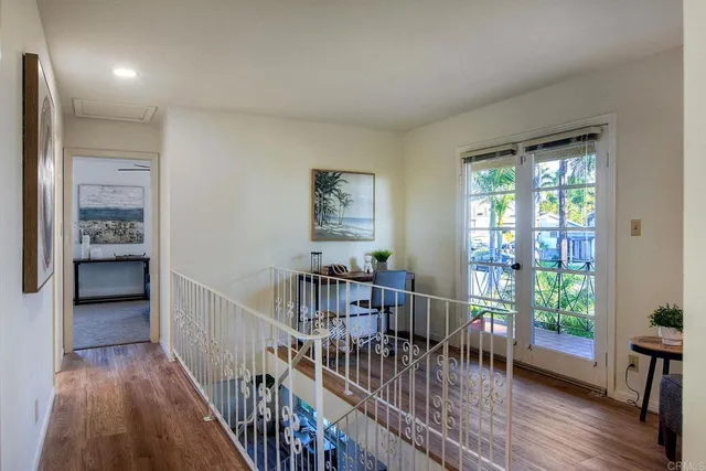 a view of a room with furniture and wooden floor
