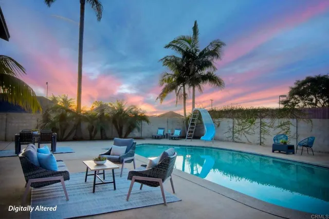 a view of a chairs and table in patio with a lake view