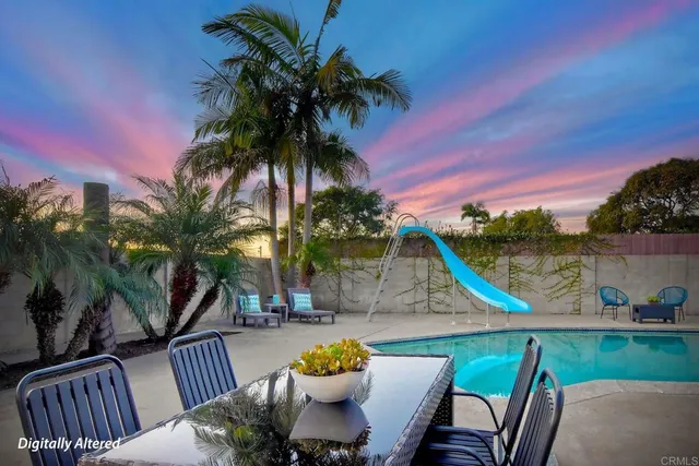 a view of a swimming pool with a patio and a garden
