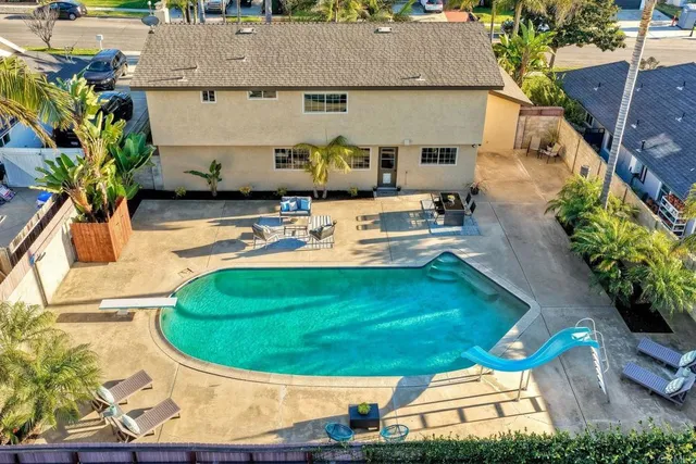 an aerial view of a house with a swimming pool