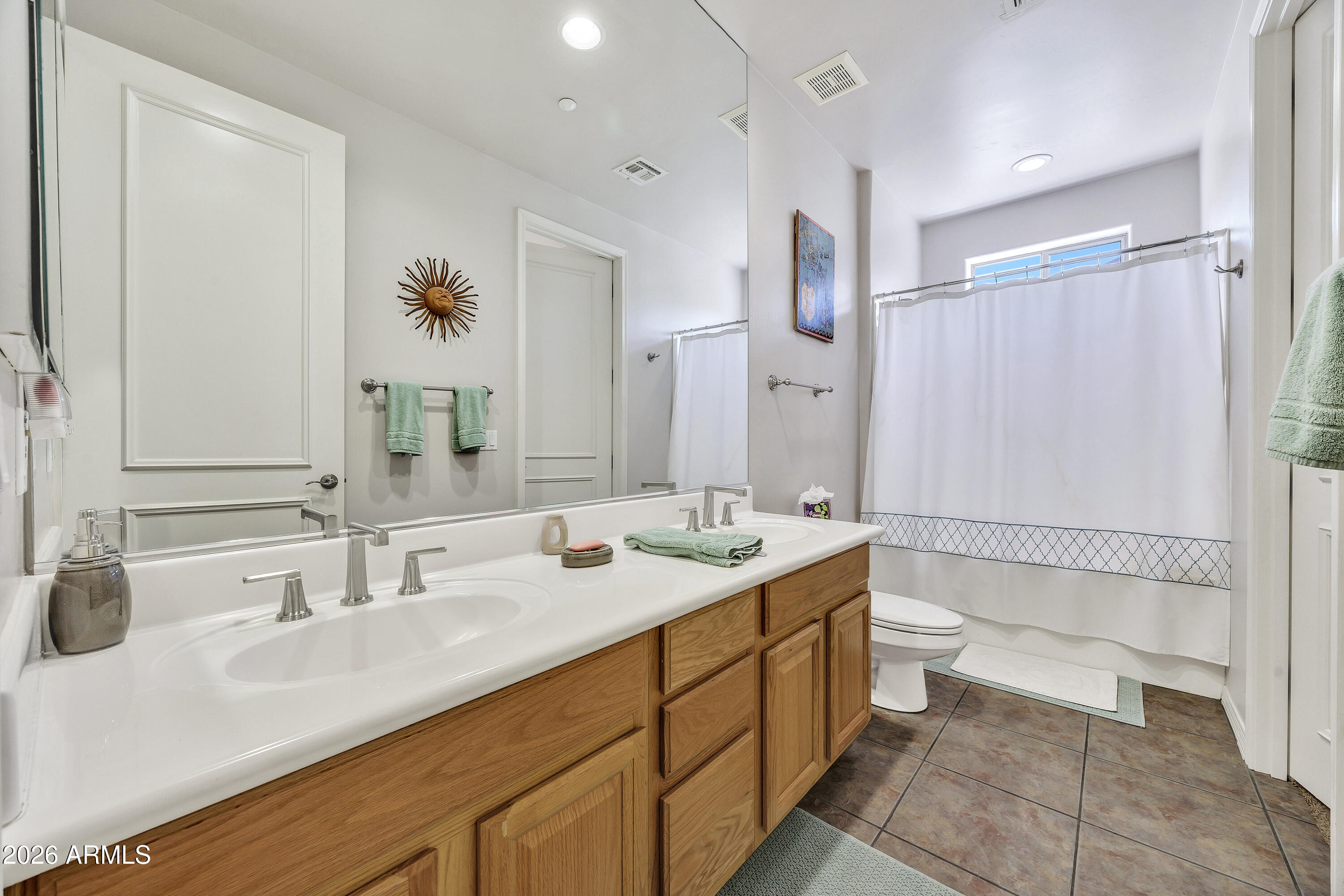 7402 Hum Road, Unit 19 Carefree, AZ 85377 - Photo 16 of 25 a bathroom with a double vanity sink toilet mirror and bathtub
