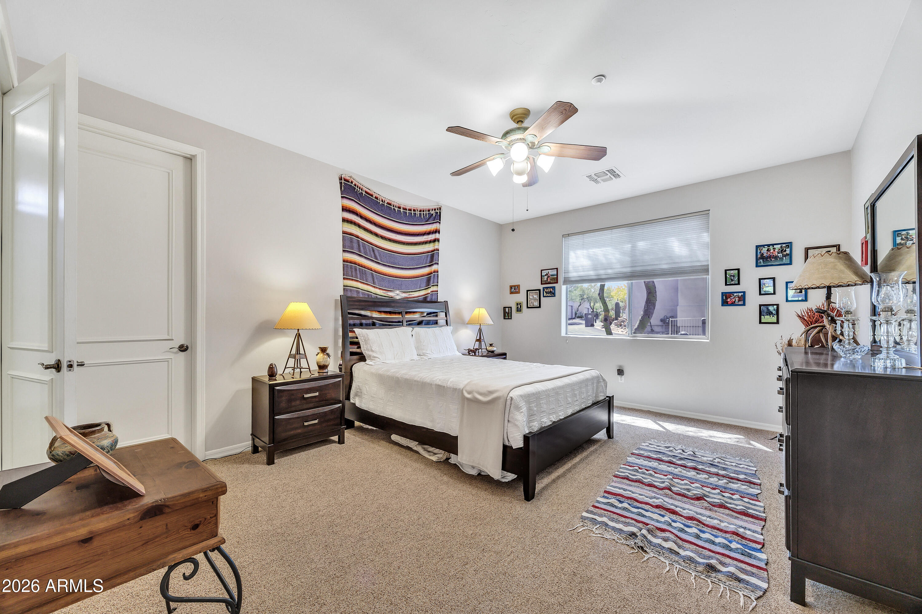 7402 Hum Road, Unit 19 Carefree, AZ 85377 - Photo 17 of 25 a spacious bedroom with a bed and a chandelier