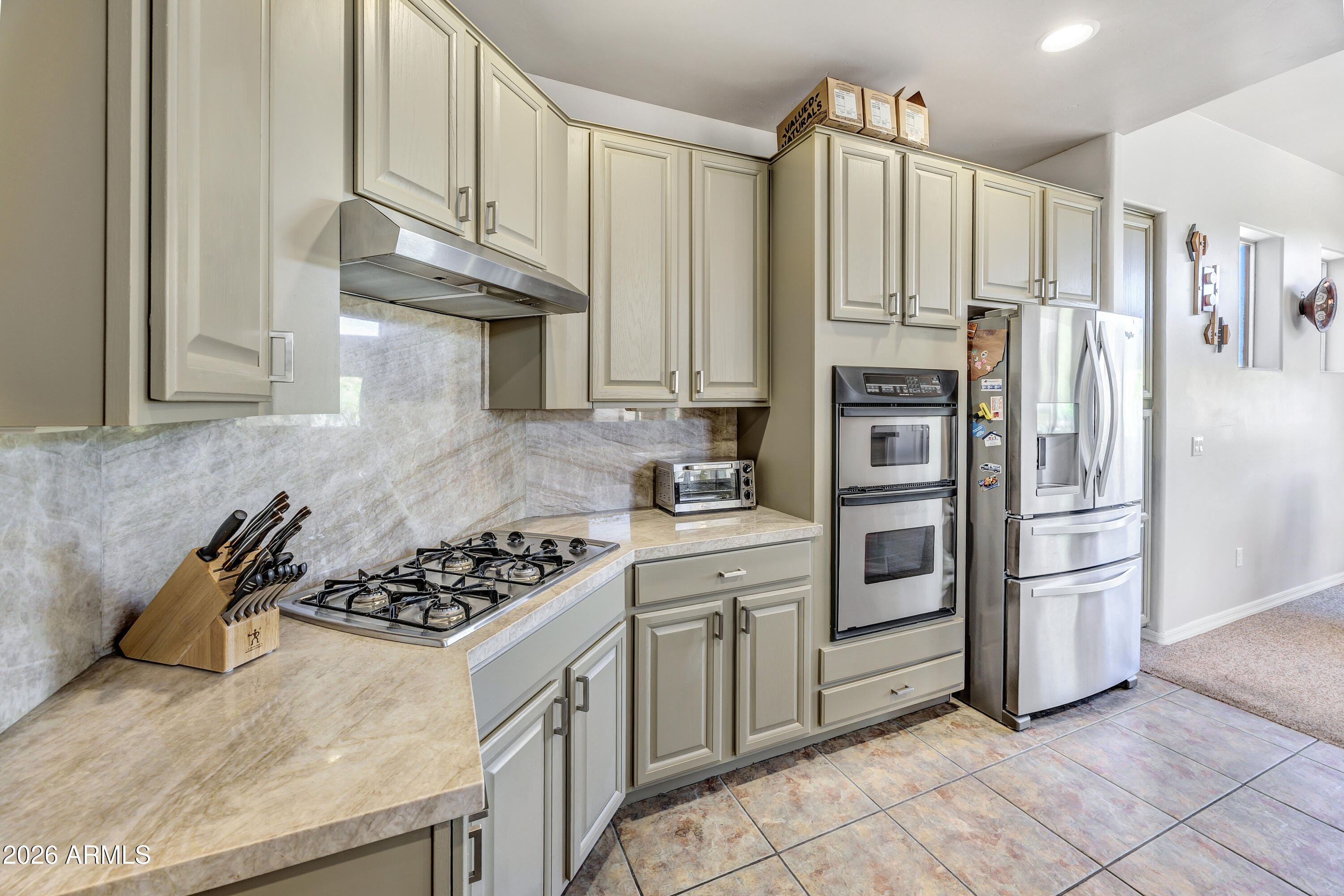 7402 Hum Road, Unit 19 Carefree, AZ 85377 - Photo 4 of 25 a kitchen with stainless steel appliances a refrigerator sink and cabinets