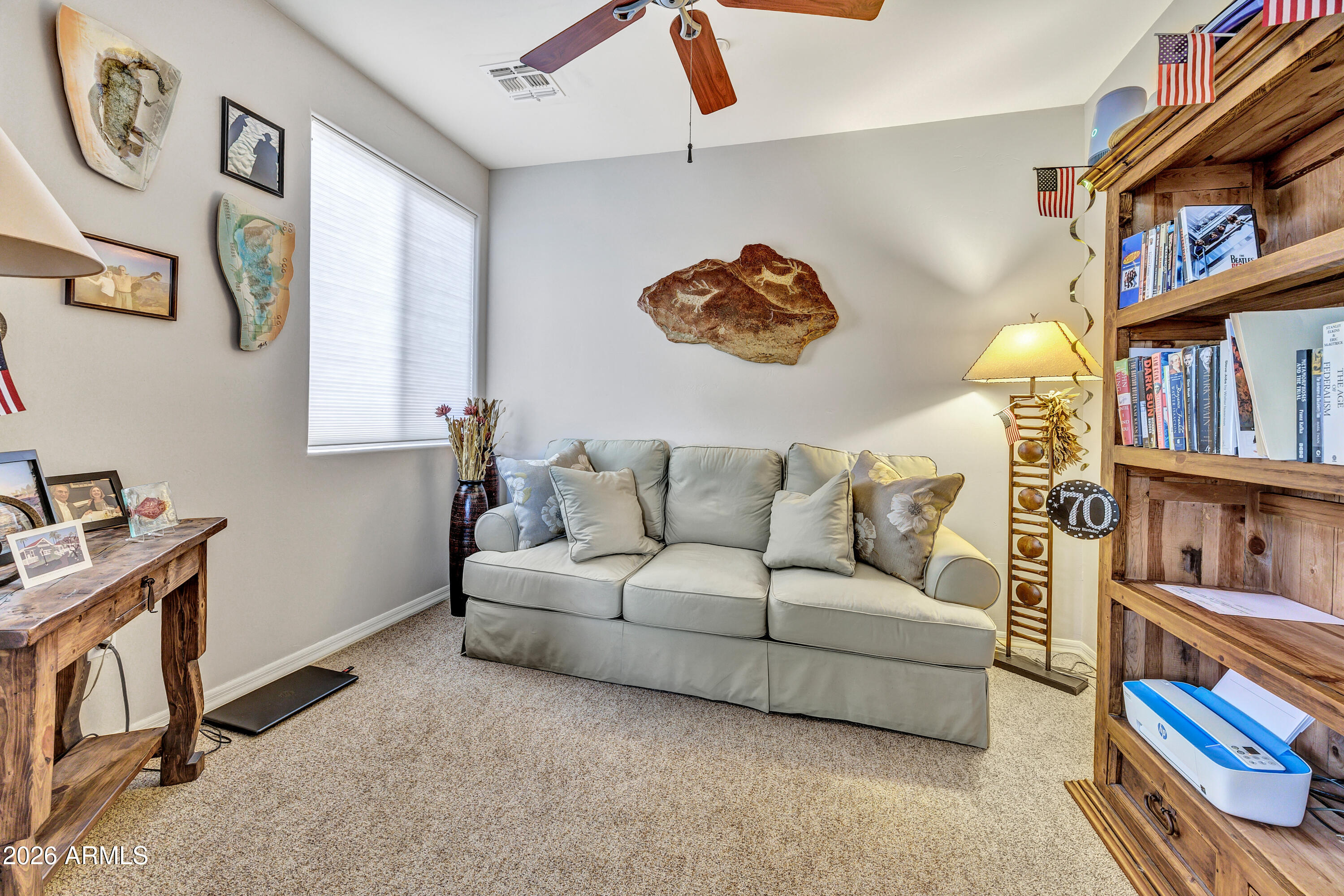 7402 Hum Road, Unit 19 Carefree, AZ 85377 - Photo 5 of 25 a living room with furniture and a book shelf